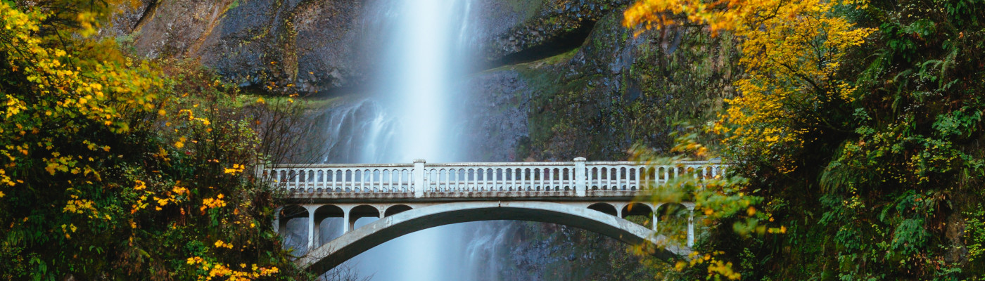 Waterfall behind bridge